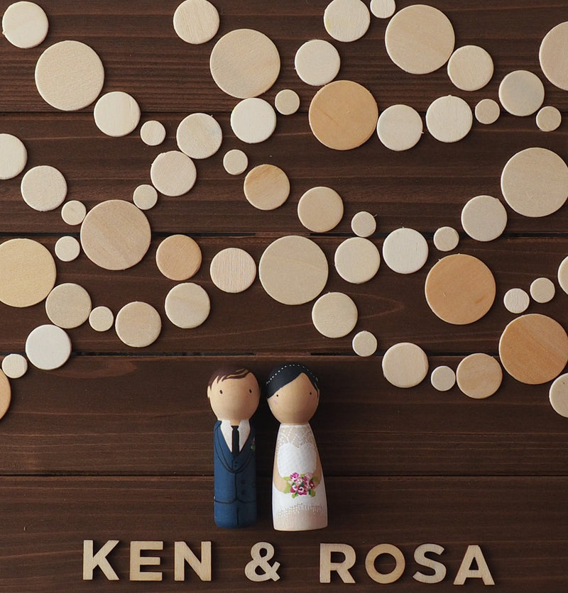 Personalized Wedding Guest book with hand-painted bride and groom peg dolls.   Have your guests sign a wooden circle, depicting lantern lights.  Hang this guestbook after the wedding to preserve beautiful memories of your special day for many years to come.  This 28"x11" wooden Wedding guest book alternative consist of up to 110 sign-able wooden circles.  It is sufficient for at least 150 guests.