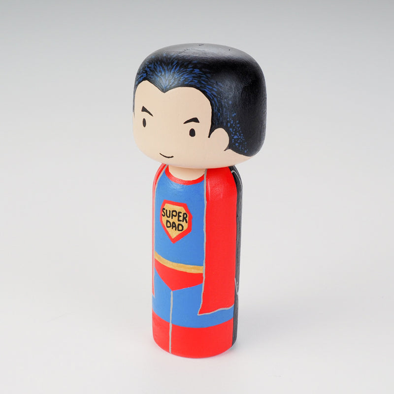 Custom super dad Kokeshi doll!  Introducing our new 2 in 1 family portrait Kokeshi dolls! 2 Designs of the same person hand-painted in 1 doll. Everyone has many roles, interests, careers, personalities, and we all wear many hats in life. Why not highlight and celebrate those in a hand-painted doll! 1 design on one side, turn the doll around and it shows another design. The toughest part is probably to choose the 2 roles you like us to paint.