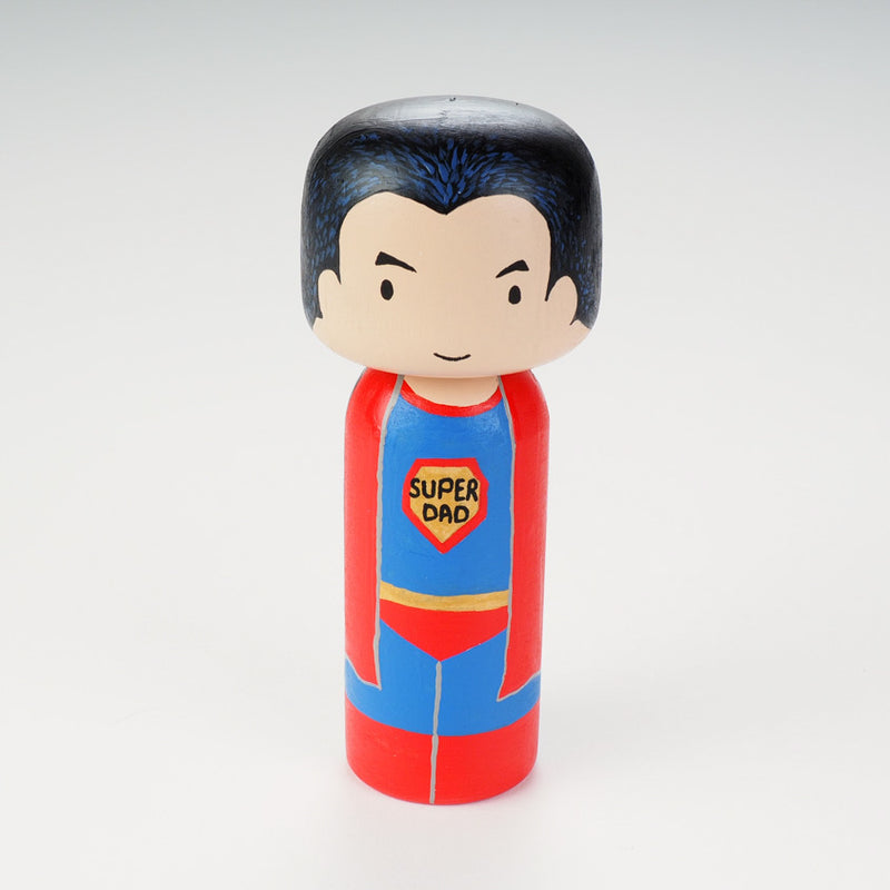 Custom super dad Kokeshi doll!  Introducing our new 2 in 1 family portrait Kokeshi dolls! 2 Designs of the same person hand-painted in 1 doll. Everyone has many roles, interests, careers, personalities, and we all wear many hats in life. Why not highlight and celebrate those in a hand-painted doll! 1 design on one side, turn the doll around and it shows another design. The toughest part is probably to choose the 2 roles you like us to paint. 
